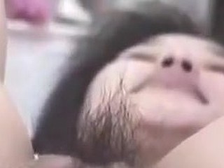 Korean slut with big pussy and pouty lips gets wicked on camera. She stuffs her hirsute pussy with fingers, metal balls and even a bottle. This cunt can gulp a lot of cock juice too!
