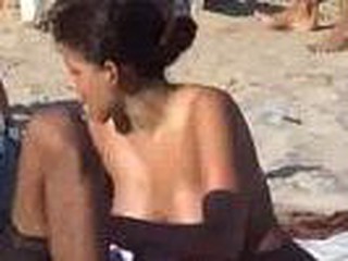 Sexy latina spied on beach with hidden cam, fine looking girl with lovely big boobies sitting down, she gets up and quick glimpse of pussy, hot bitch.