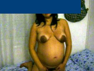 This pregnant wife with glamorous cinnamon skin is about 8 months pregnant. That babe shows her big belly and her breasts are bare - her areolas are very dark and large.